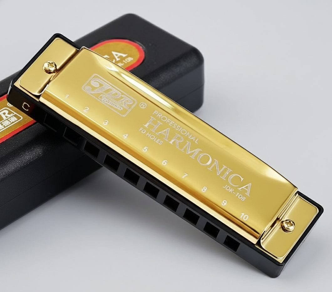 Gold harmonica with '10 hole, C key' text on a black background